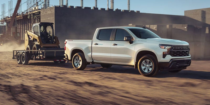 Chevrolet Silverado towing trailer on road