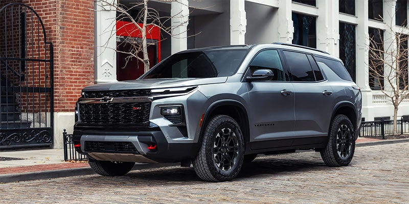 2027 Chevrolet Traverse RS SUV parked on a city street 